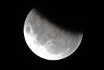 The moon is 37 per cent obscured by the Earth's shadow during the partial lunar eclipse above Sydney on June 4, 2012. (Torsten Blackwood/AFP/GettyImages)