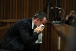 South African Paralympic track star Oscar Pistorius wipes his face during his trial in Court in Pretoria on April 7, 2014. (Themba Hadebe/AFP/Getty Images)